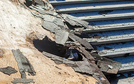Roof repair, exposed damaged underlayment
